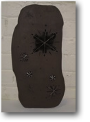 images of stars on black clay with white decoration